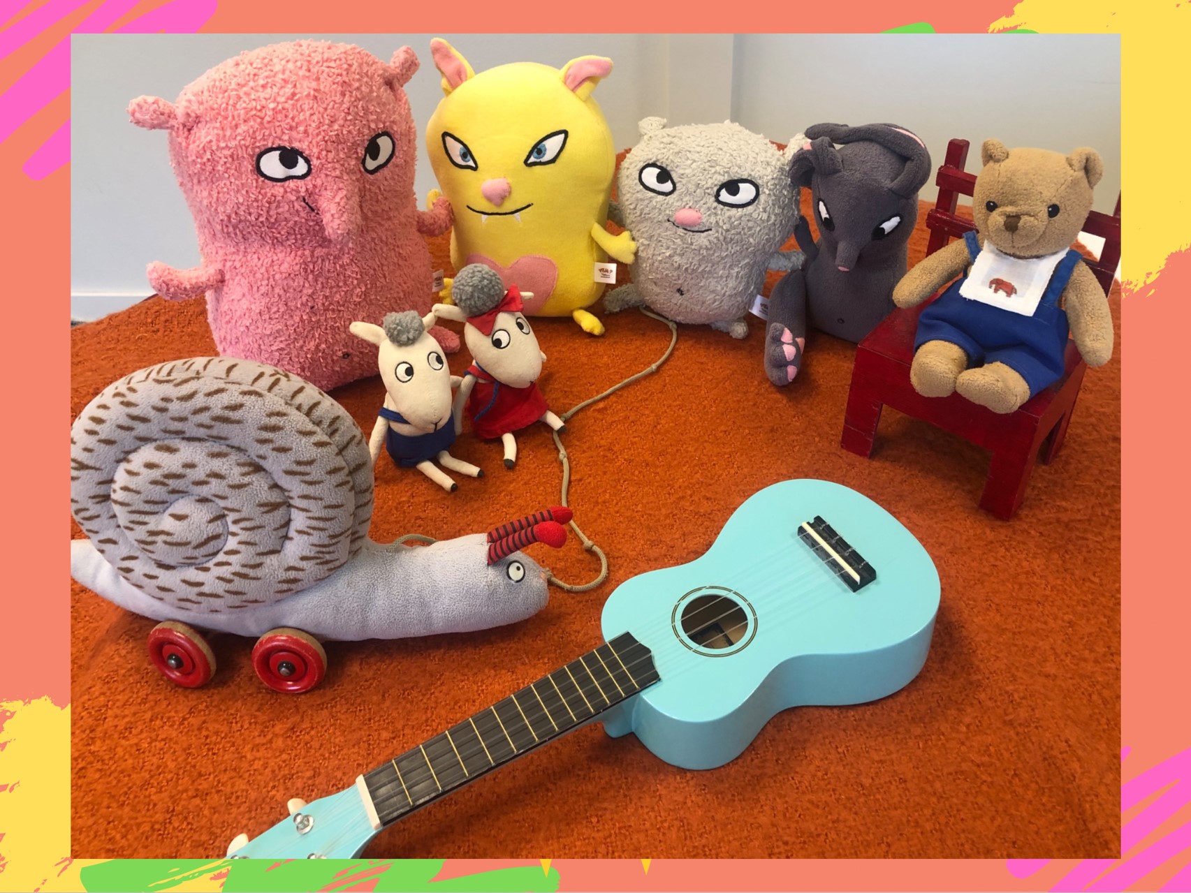 Gosedjur i en halvcirkel runt en ukulele.