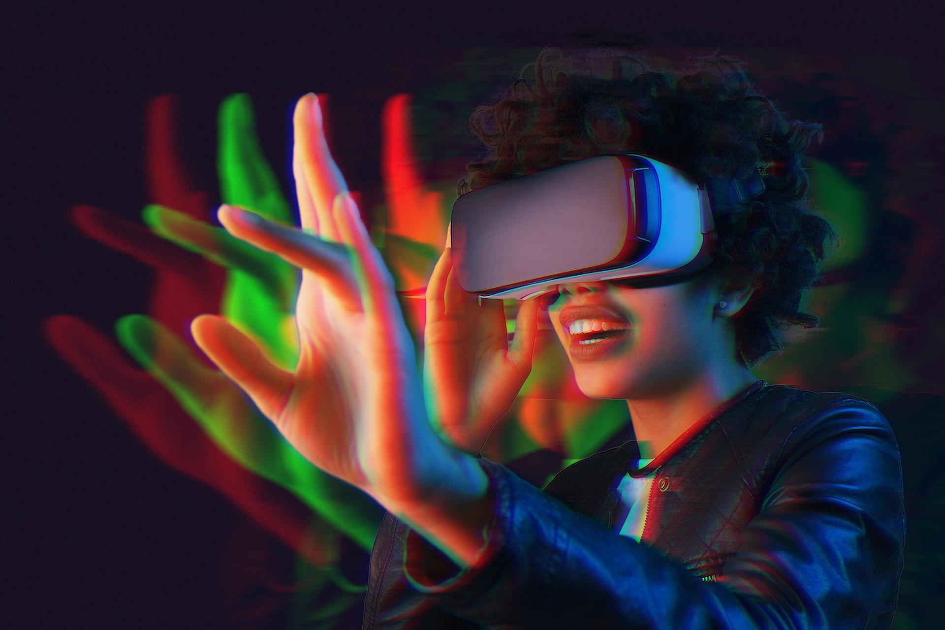 Ung person med VR-glasögon som håller upp sin hand framför sig
