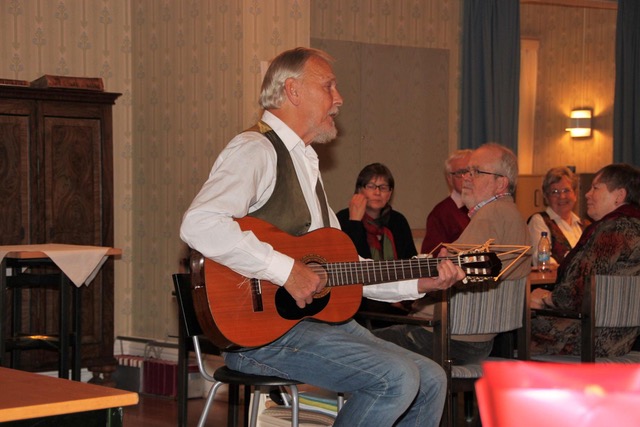 Trubaduren Bertil Olsson spelar på en gitarr